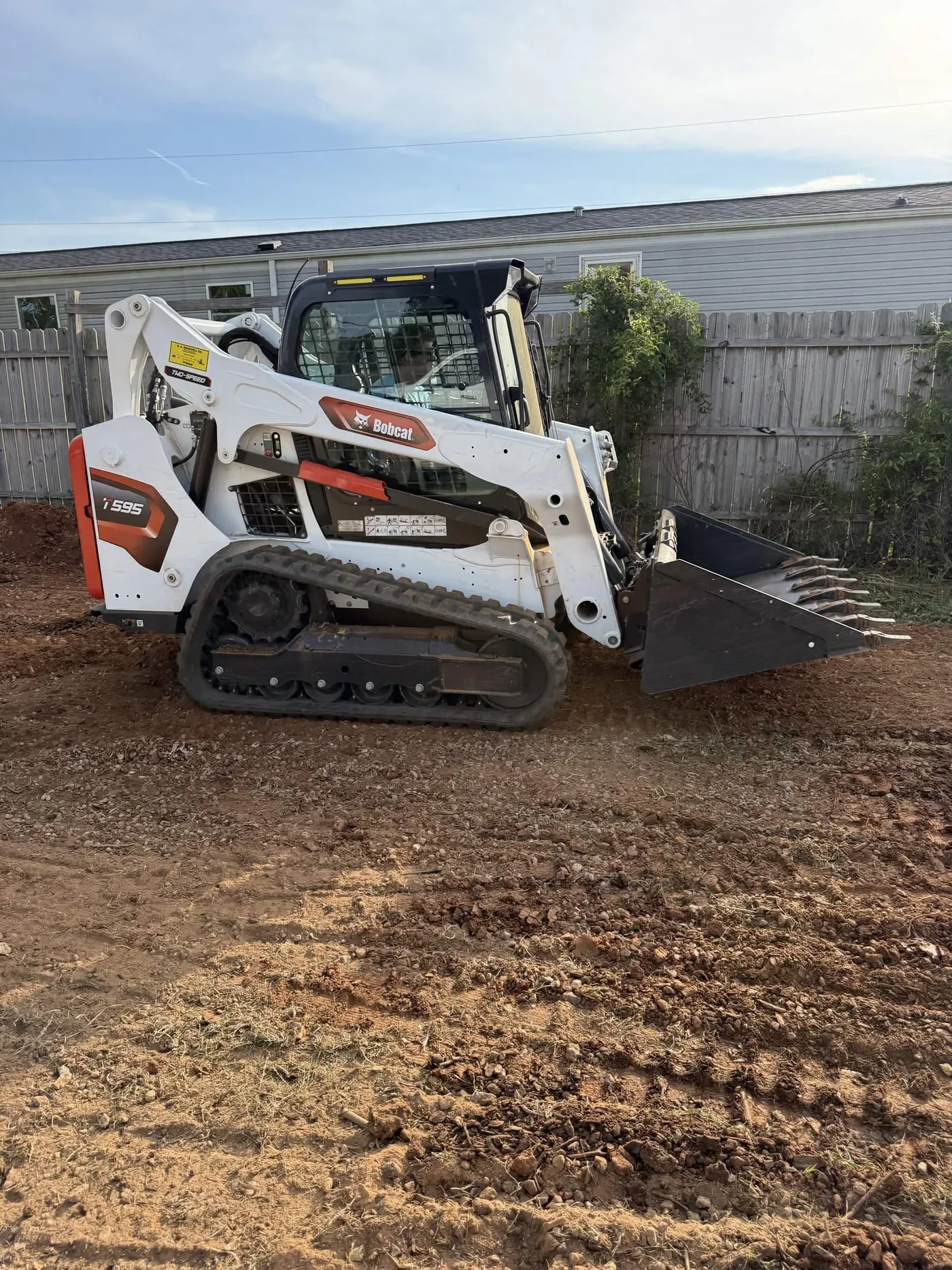 An operator cutting grade with a tooth bucket