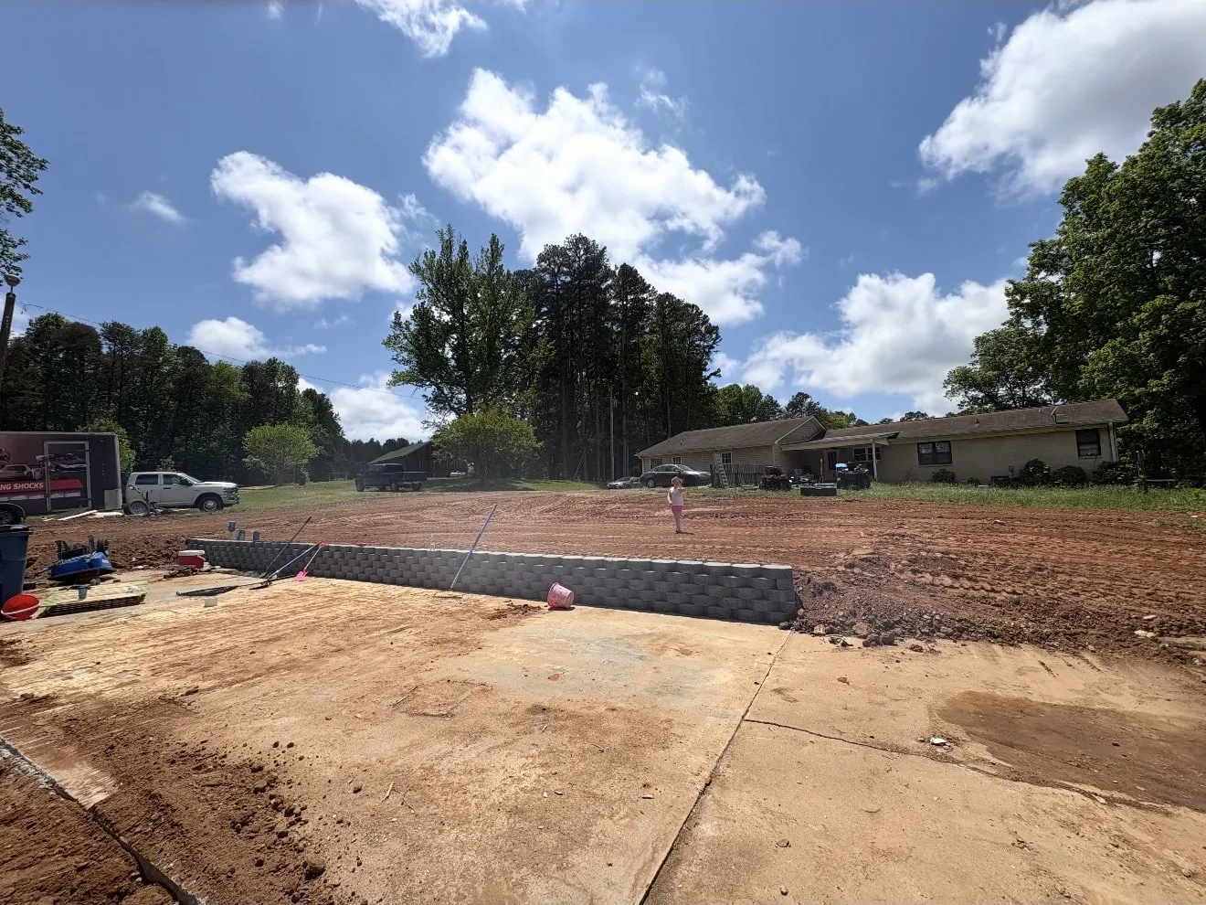 A cut pad with a new retaining wall and regraded surrounding lot